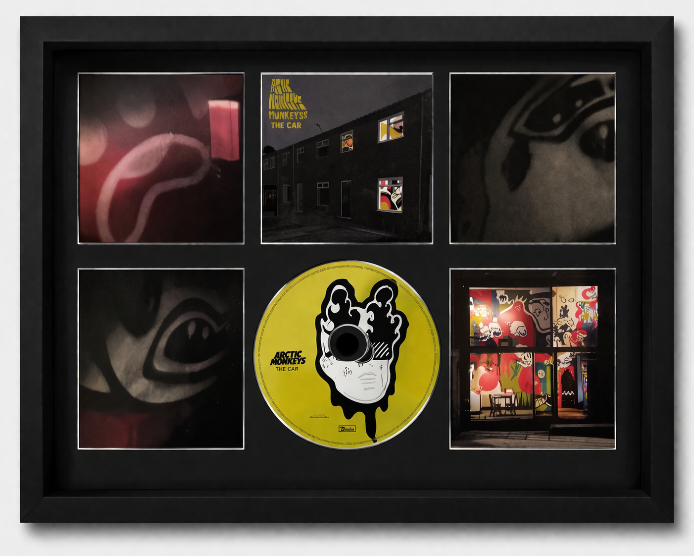 Framed album cover with a yellow disc and black and white illustration, surrounded by smaller images.