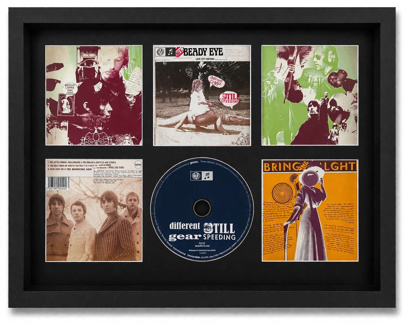 Framed display of album covers and a CD with text on a black background
