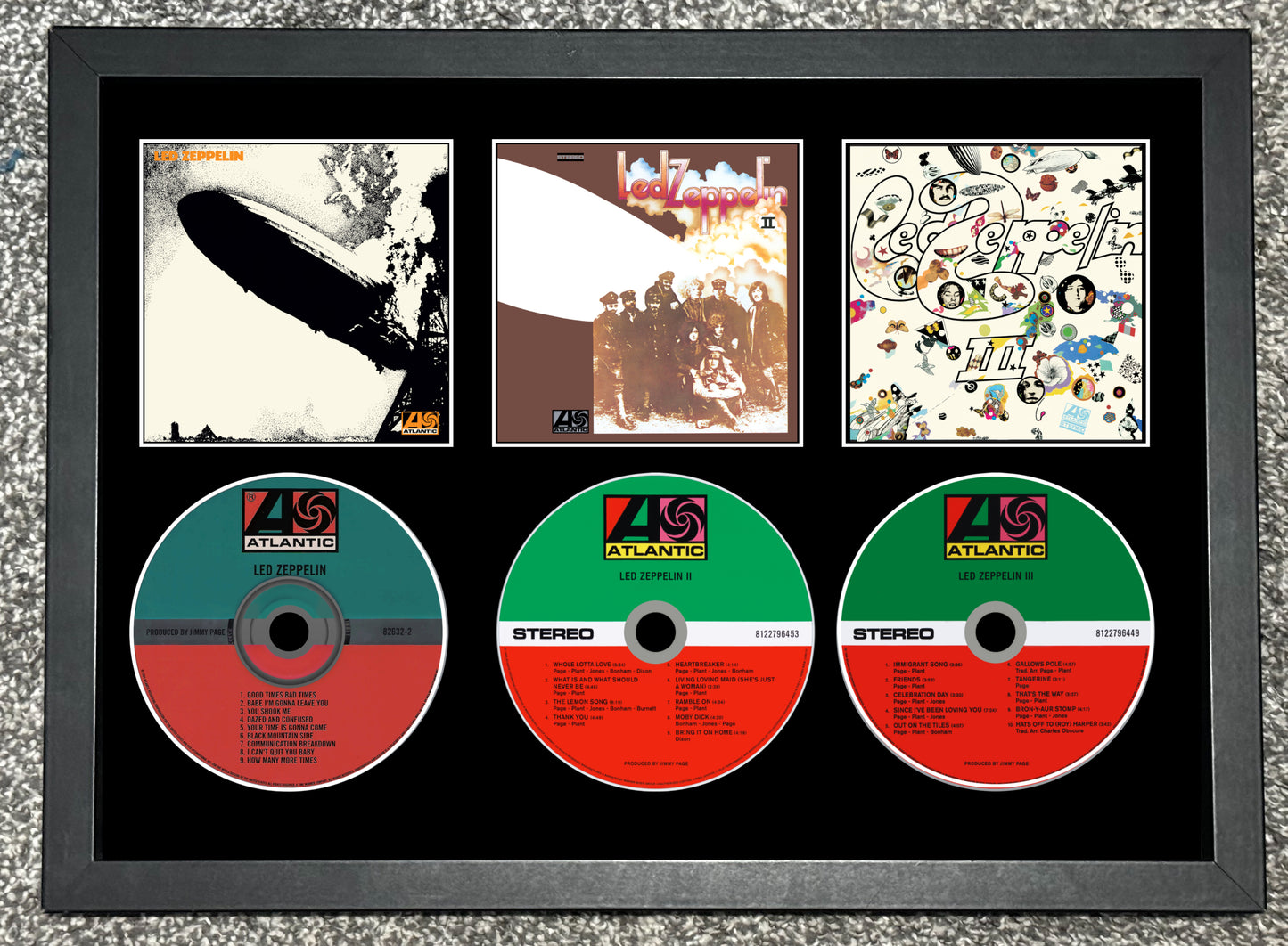 Framed display of album covers and CDs with Atlantic Records logo.
