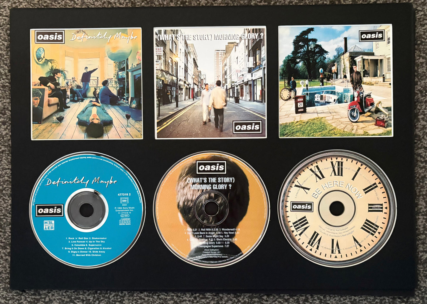 Oasis | Definitely Maybe | What’s The Story (Morning Glory?) | Be Here Now | Triple Retro Mounted CD Wall Display | Frame Not Included |