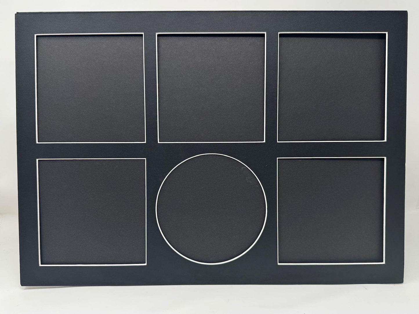 Black frame with five square slots and one circular slot on a white background