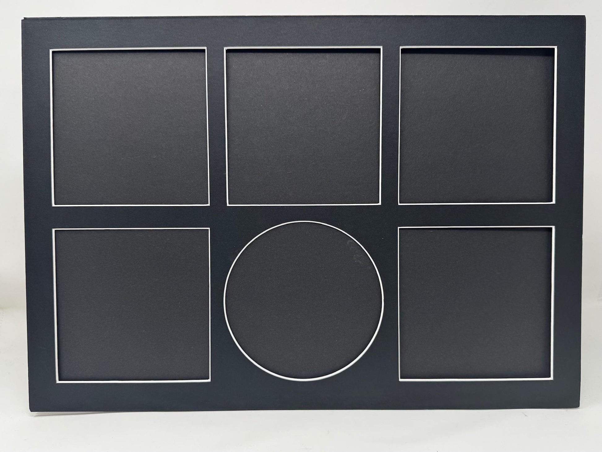 Black frame with five square slots and one circular slot on a white background