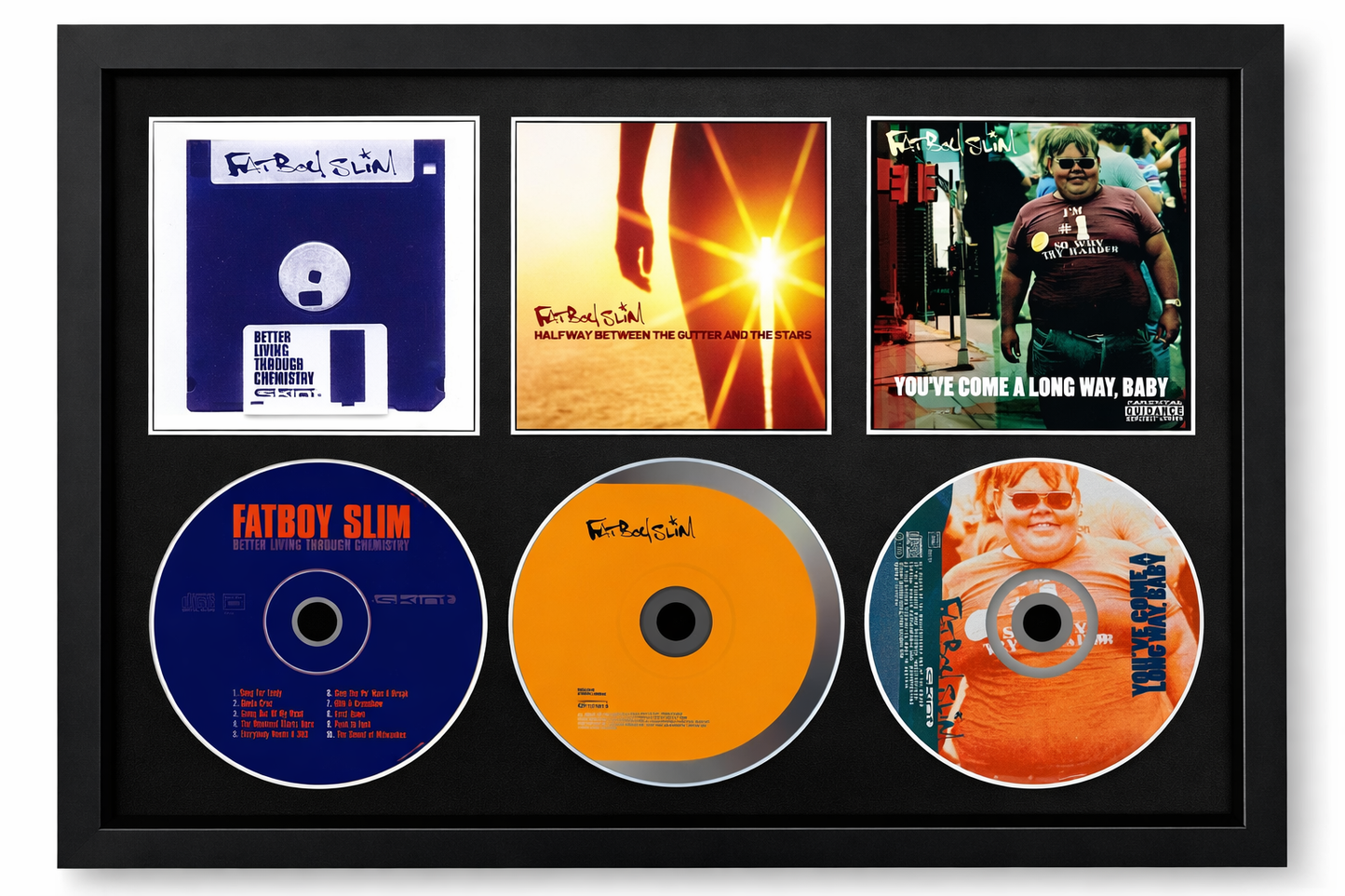 Framed display of Fatboy Slim music CDs and covers.