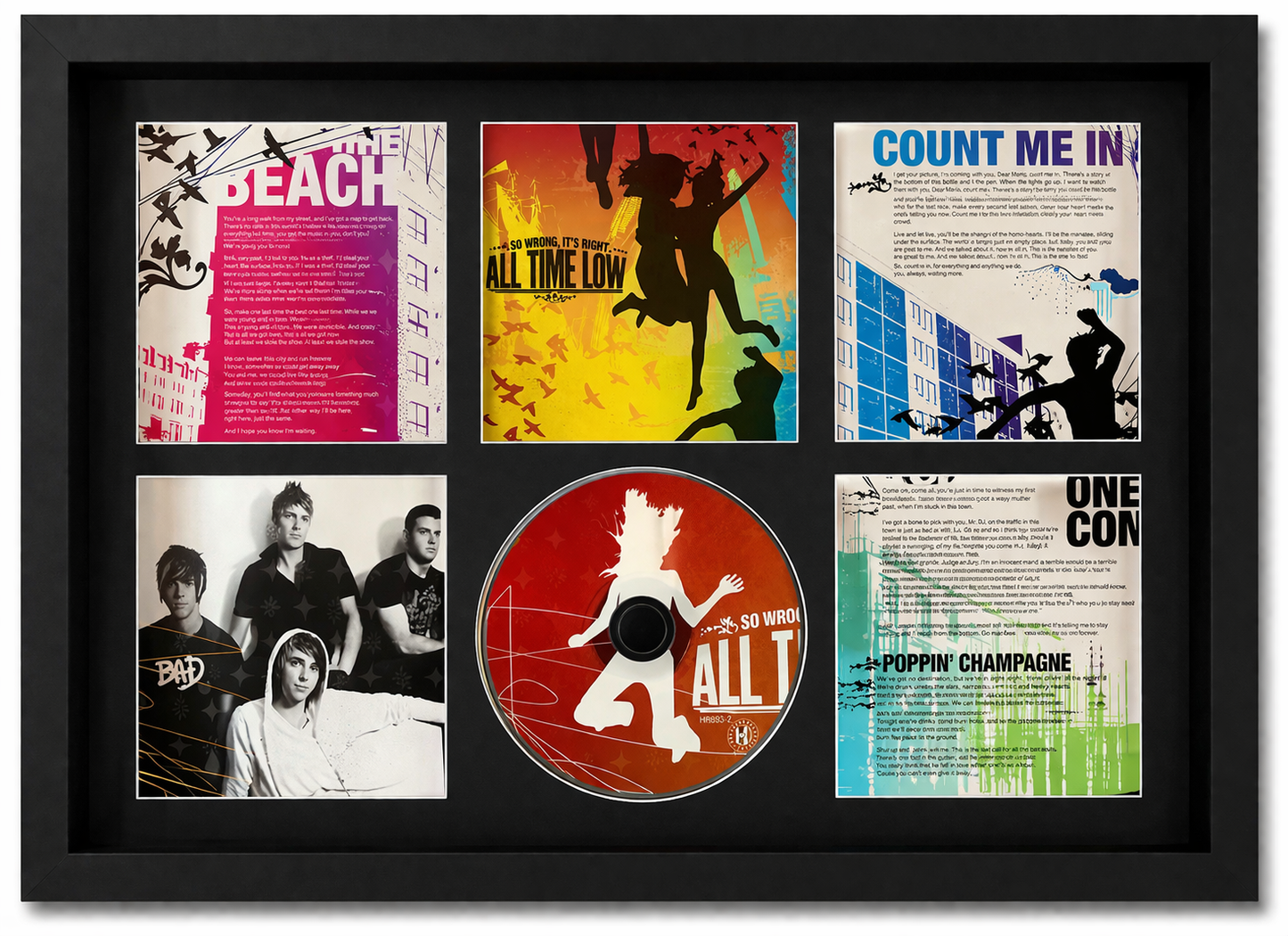 Framed display of a CD and album covers with artistic designs and text.