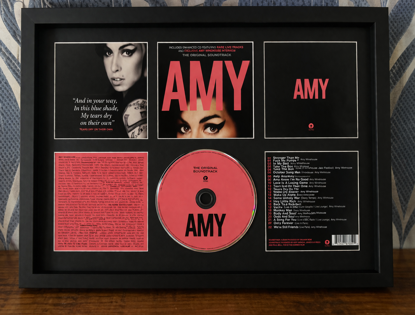 Framed album cover of 'Amy' with a pink disc and text