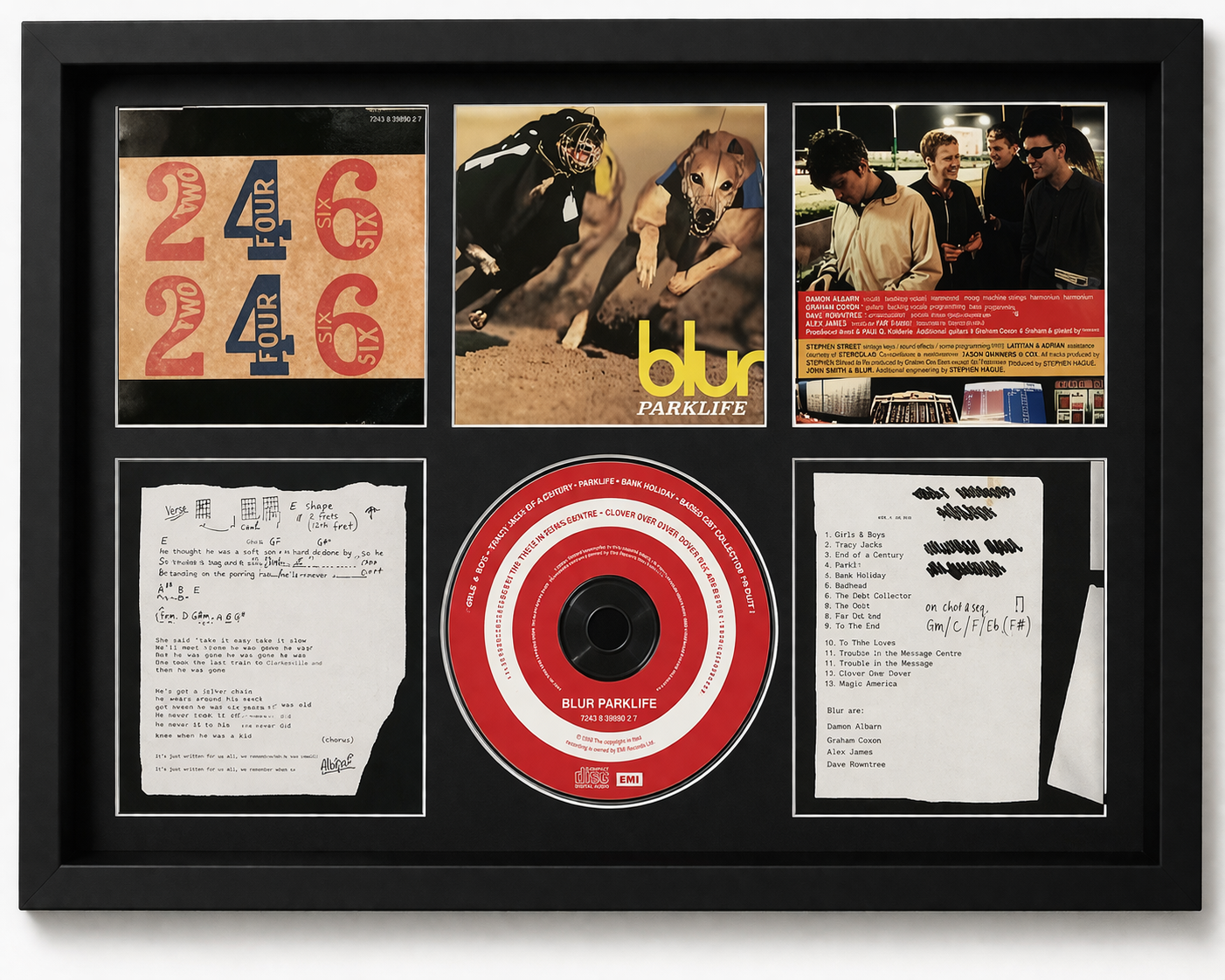 Framed album cover and related items of the band Blur, including a CD and lyrics.