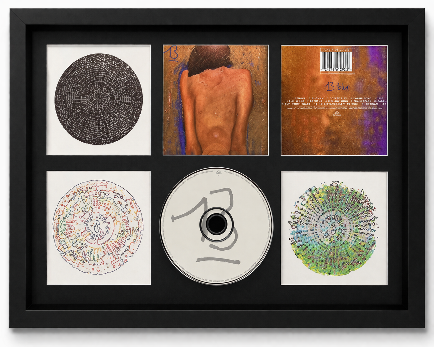 Framed album cover and related items of the band Blur, including a CD and lyrics.
