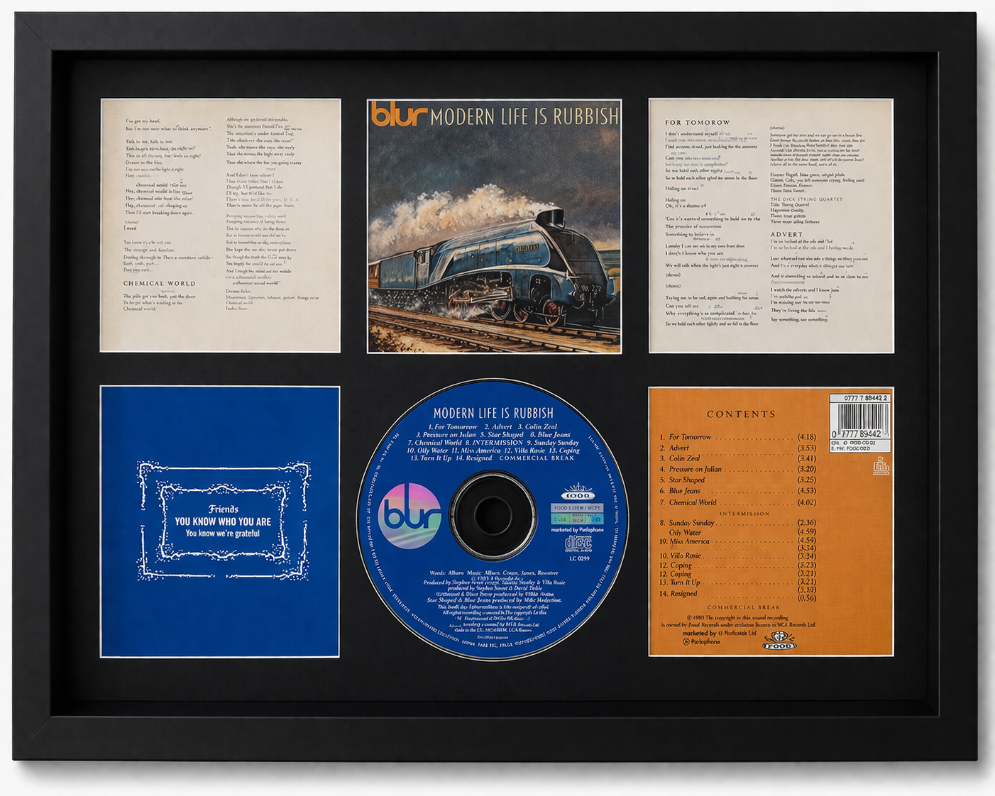 Framed album cover and related items of the band Blur, including a CD and lyrics.