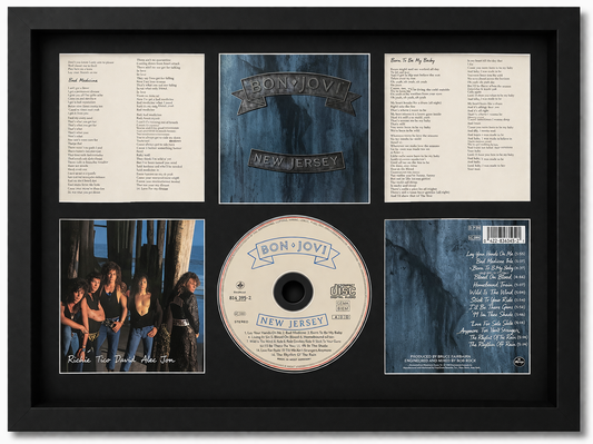 Framed album cover and related items of the band Blur, including a CD and lyrics.