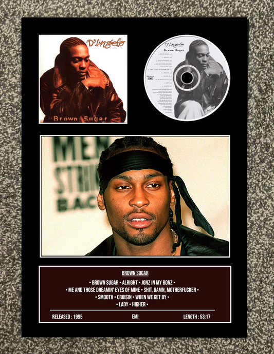 Framed album cover with a portrait of a person, a CD, and text on a textured surface.