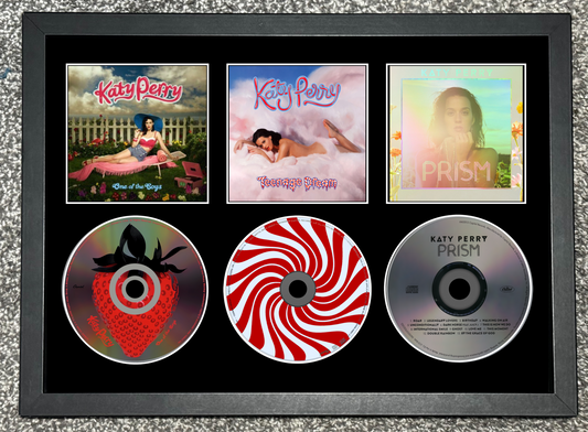 Framed display of Katy Perry's music albums and CDs.