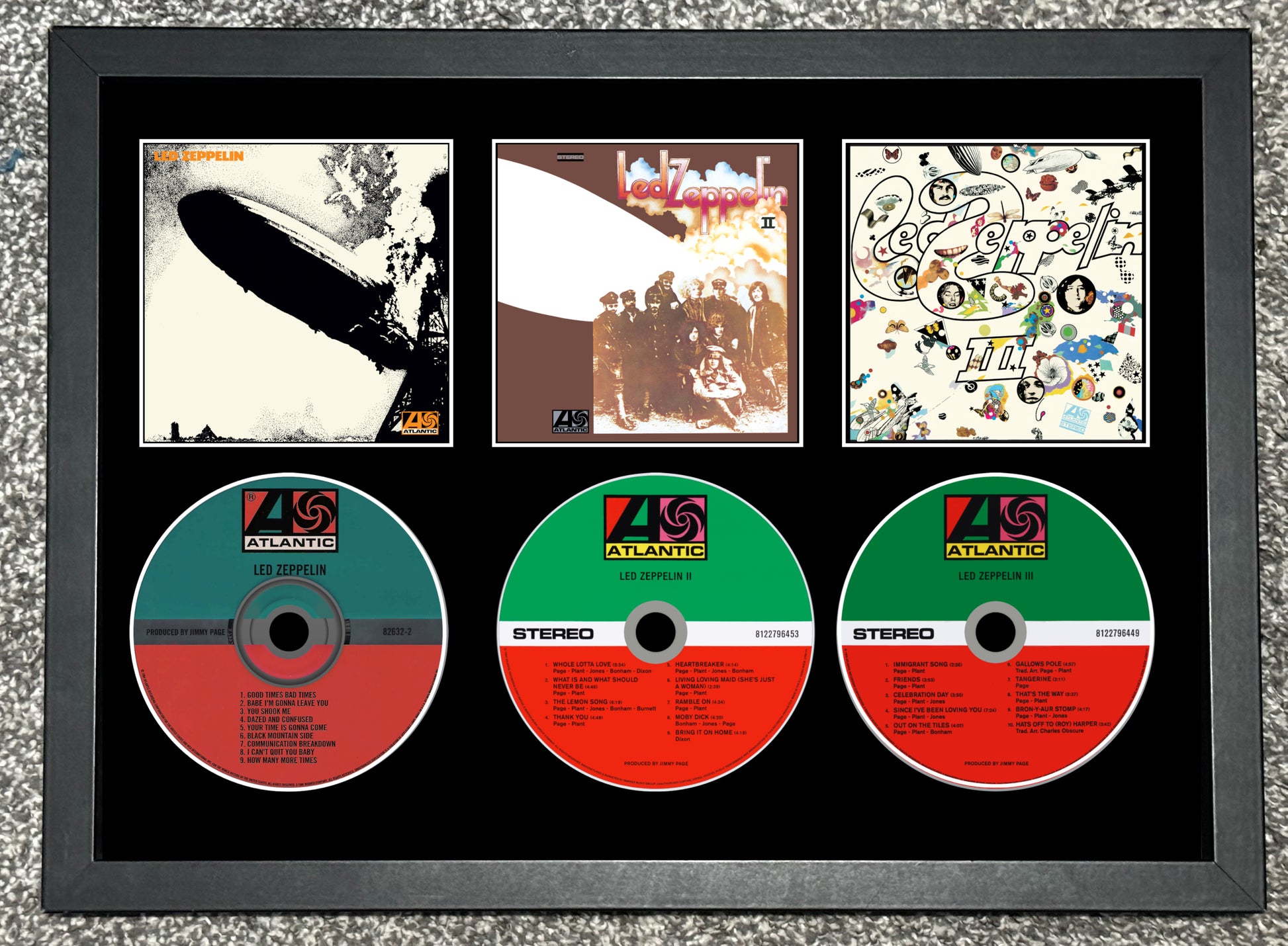 Framed display of album covers and CDs with Atlantic Records logo.