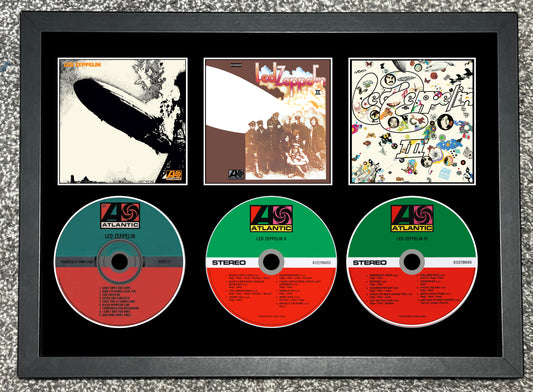 Framed display of album covers and CDs with Atlantic Records logo.