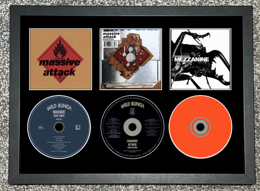 Framed album cover and CDs of Massive Attack's 'Mezzanine' and 'Mild Bunch'.