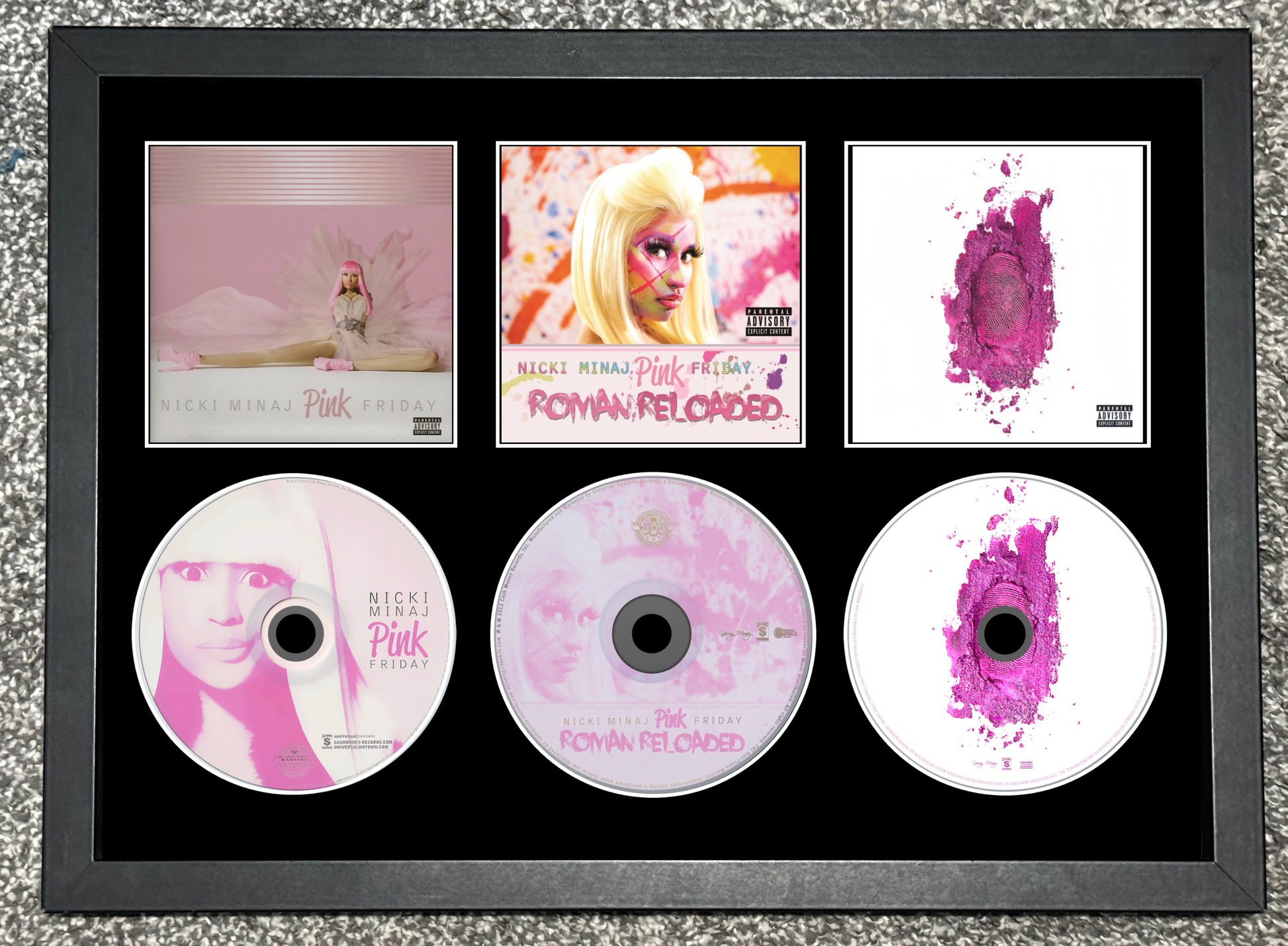 Framed Nicki Minaj music albums and CDs with pink and white design.