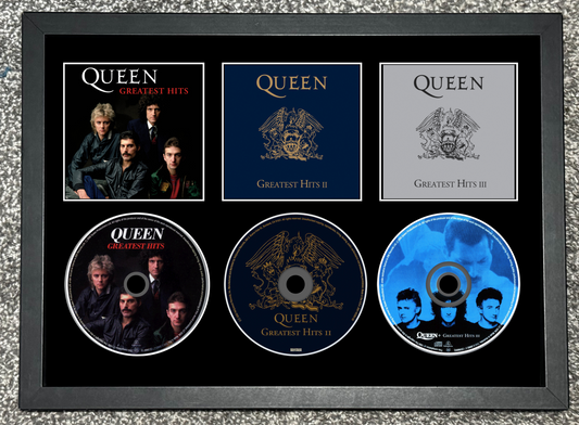 Framed Queen Greatest Hits album collection with five CDs and cover images.