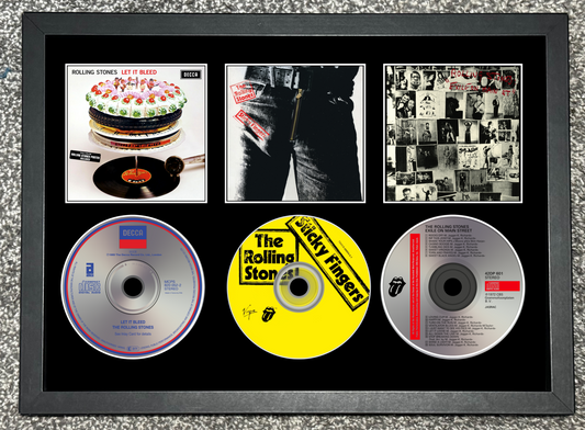 Framed display of Rolling Stones music CDs and album covers.