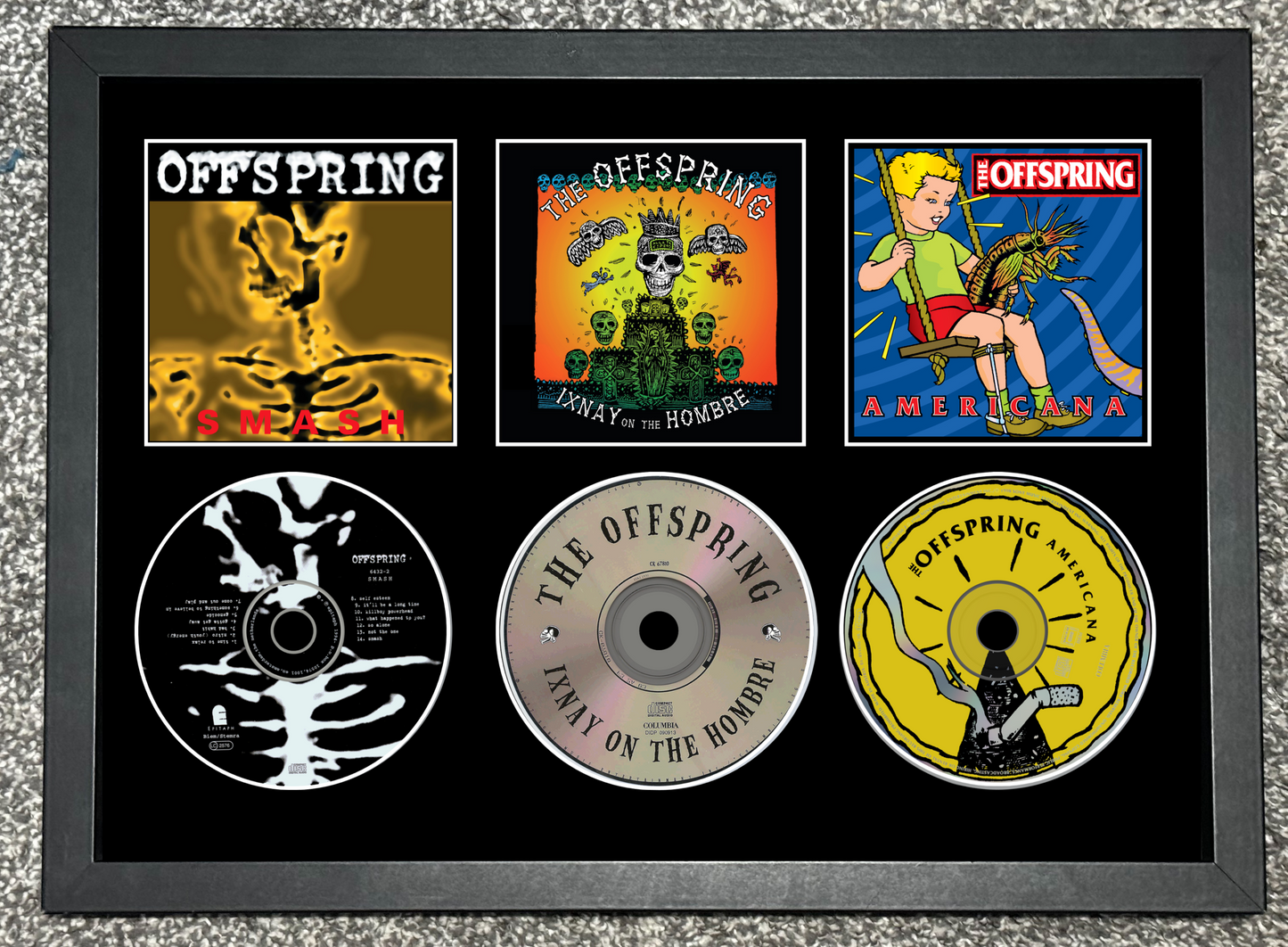 Framed collection of The Offspring album covers and CDs on a textured surface