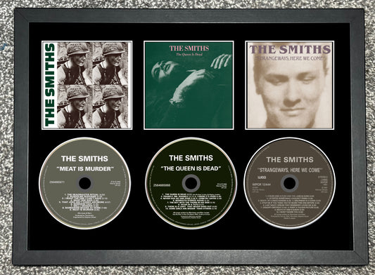 Framed album covers and CDs of The Smiths on a textured gray background