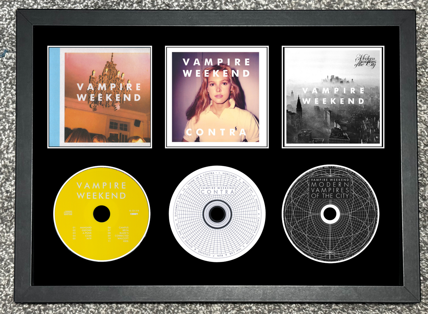 Framed display of Vampire Weekend music albums and CDs