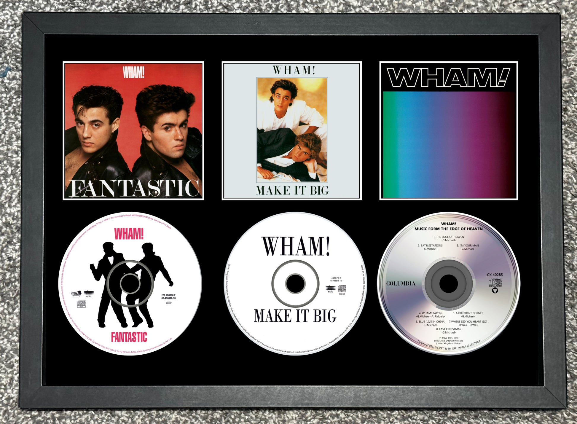 Framed Wham! music album covers and singles on a textured gray background