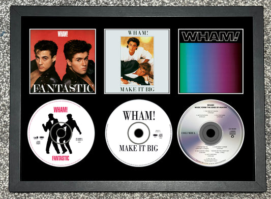 Framed Wham! music album covers and singles on a textured gray background