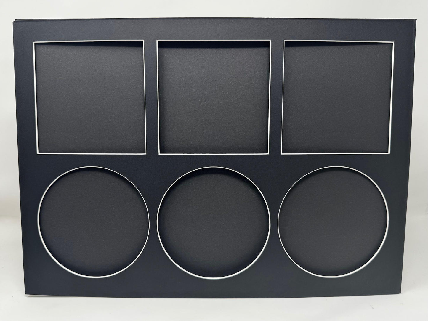 Black display box with square and circular cutouts on a white background