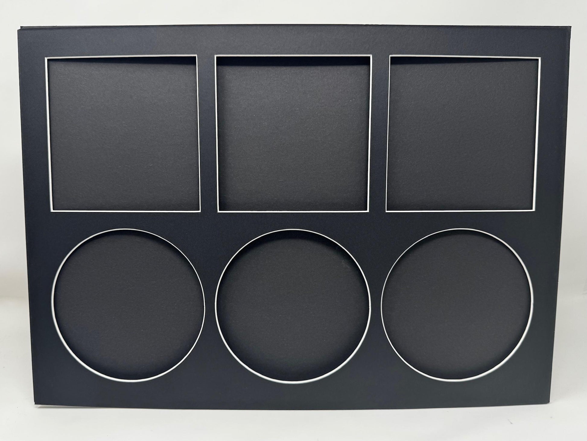 Black display box with square and circular cutouts on a white background